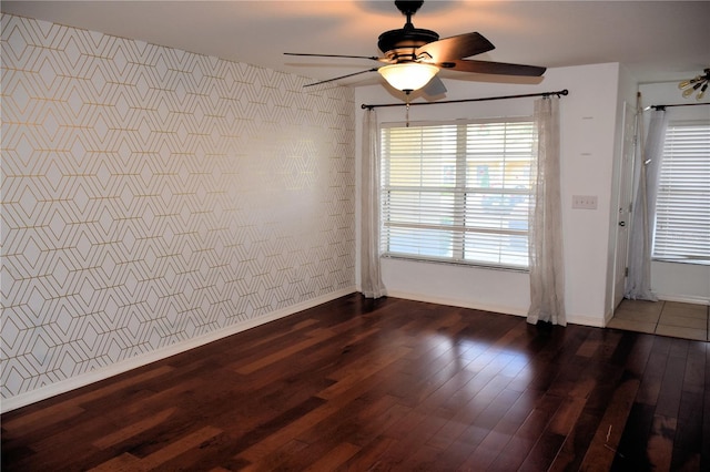 empty room featuring dark hardwood / wood-style flooring and ceiling fan