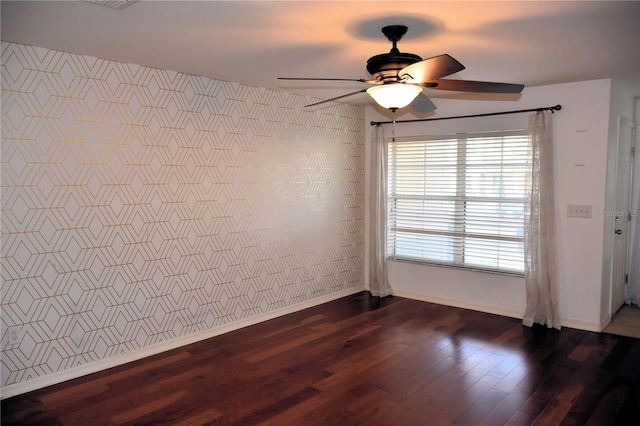 empty room featuring ceiling fan and dark hardwood / wood-style floors