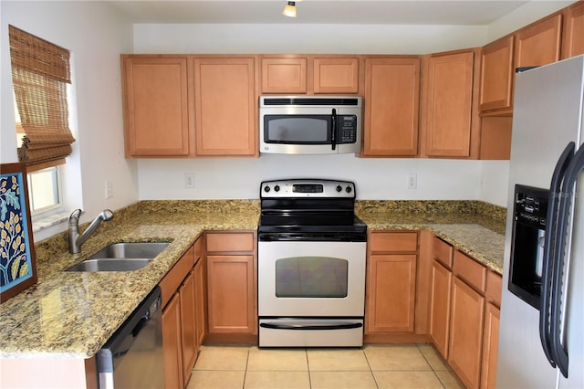 kitchen featuring appliances with stainless steel finishes, sink, light tile patterned floors, kitchen peninsula, and light stone countertops