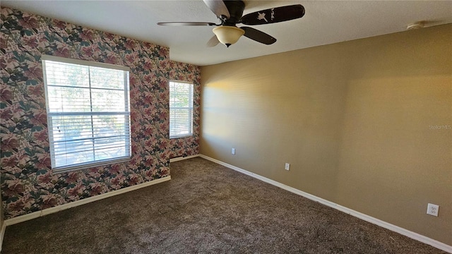 unfurnished room featuring ceiling fan and carpet