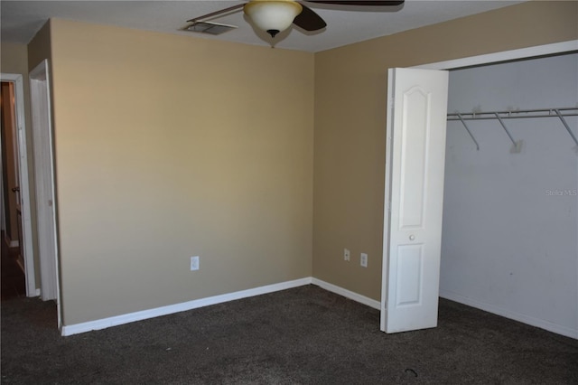 unfurnished bedroom featuring ceiling fan, dark carpet, and a closet