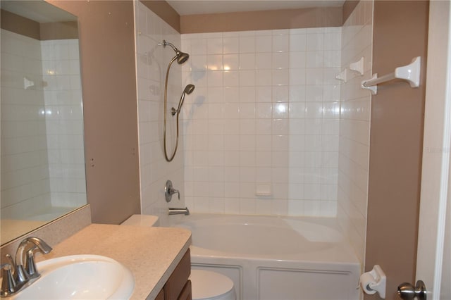 full bathroom featuring vanity, toilet, and tiled shower / bath combo