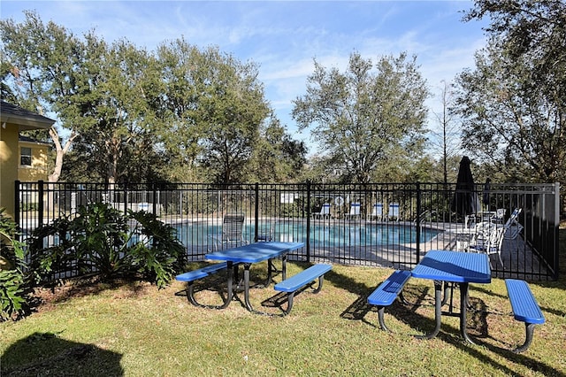 view of pool with a yard