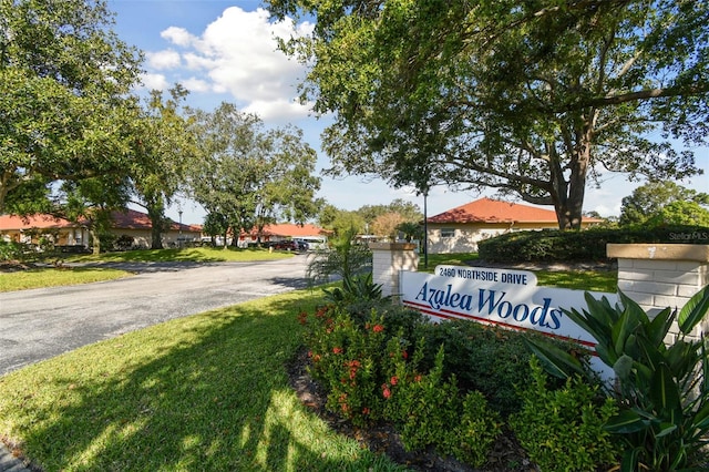 community / neighborhood sign with a yard