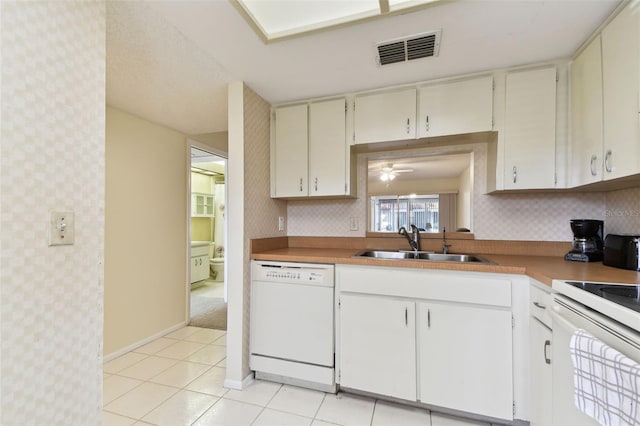 kitchen with white appliances, sink, ceiling fan, light tile patterned flooring, and white cabinetry