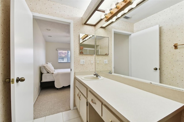 bathroom with tile patterned flooring and vanity