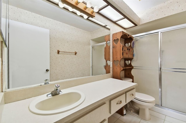 bathroom featuring tile patterned floors, vanity, toilet, and an enclosed shower