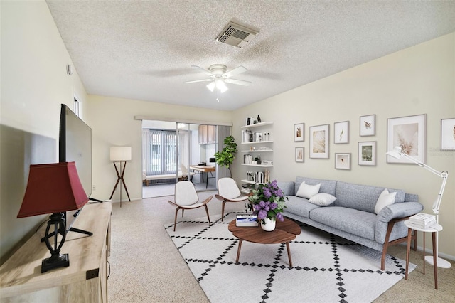 living room with a textured ceiling and ceiling fan