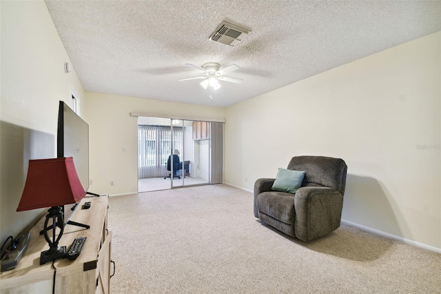 sitting room featuring ceiling fan and a textured ceiling