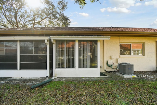 rear view of house featuring central AC