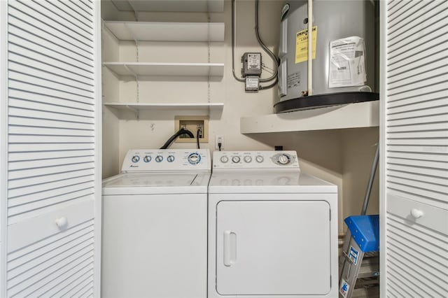 clothes washing area featuring washing machine and dryer and water heater