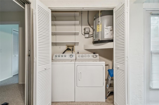 clothes washing area with electric water heater and separate washer and dryer