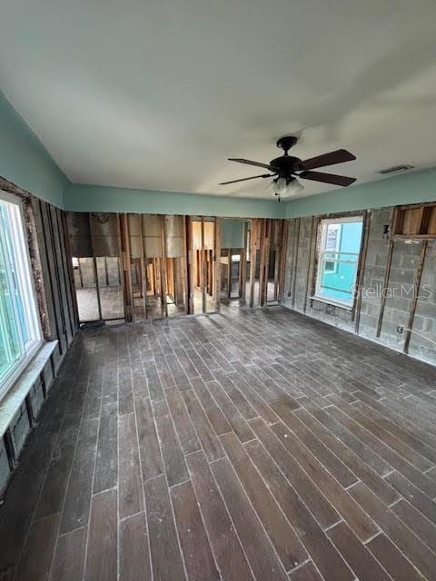 interior space with ceiling fan and dark hardwood / wood-style floors