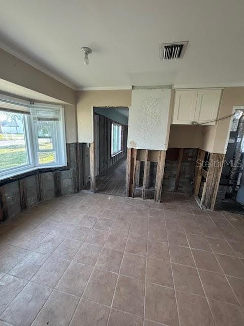 interior space with white cabinetry and crown molding