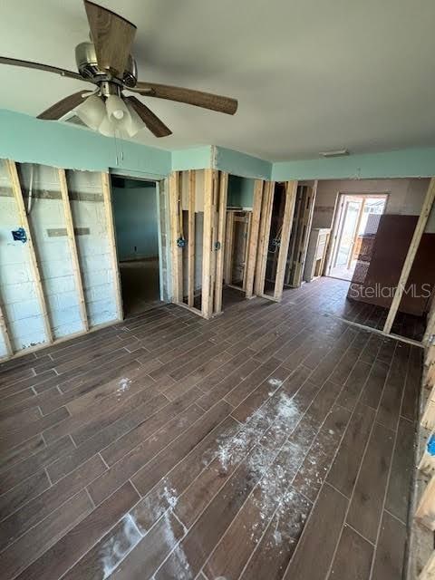 interior space featuring ceiling fan and dark wood-type flooring