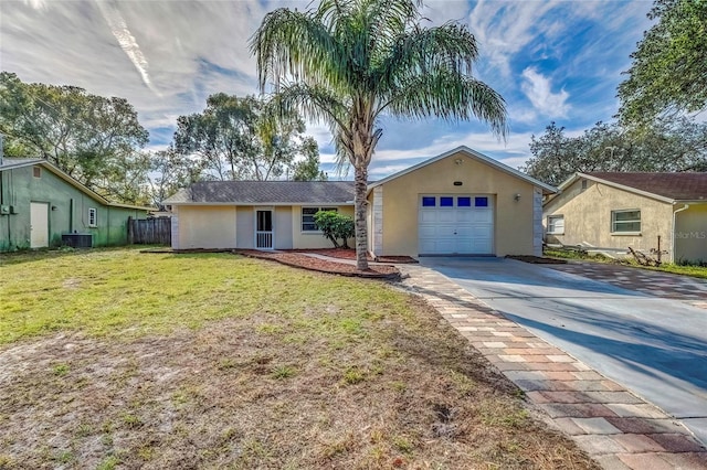 ranch-style home featuring central AC, a front lawn, and a garage