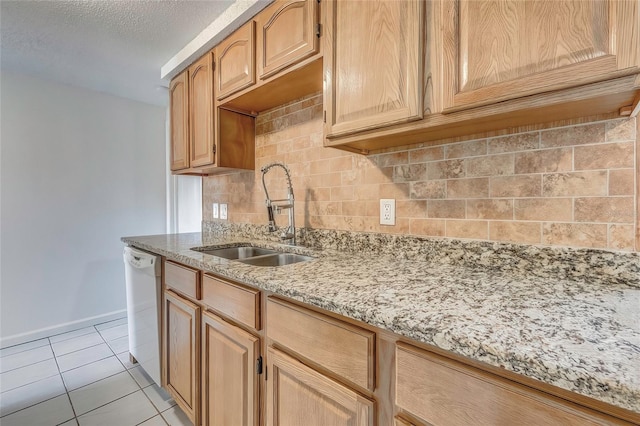 kitchen featuring light stone countertops, tasteful backsplash, a textured ceiling, white dishwasher, and sink