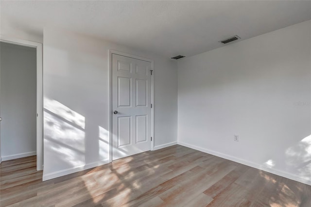 spare room featuring light hardwood / wood-style floors