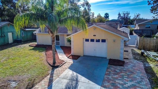 ranch-style house featuring cooling unit and a front lawn