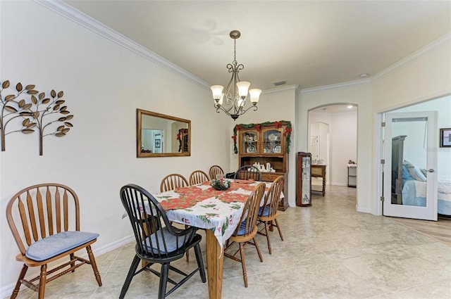 dining area with ornamental molding and a notable chandelier