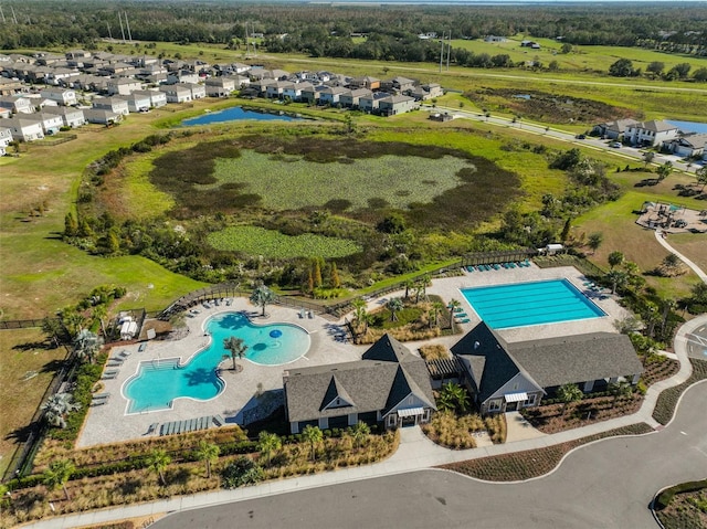 birds eye view of property featuring a water view and a residential view