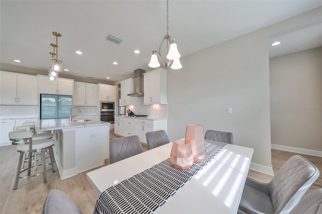 dining room with baseboards, recessed lighting, visible vents, and light wood-style floors