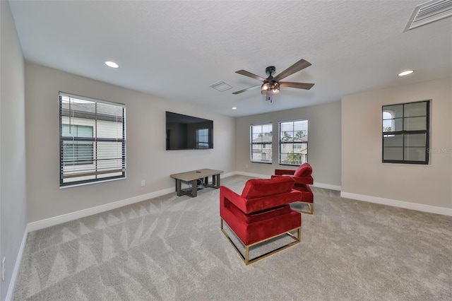 living room with visible vents, light carpet, and baseboards