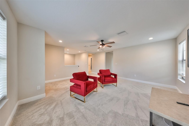 sitting room with light carpet, visible vents, baseboards, a ceiling fan, and recessed lighting