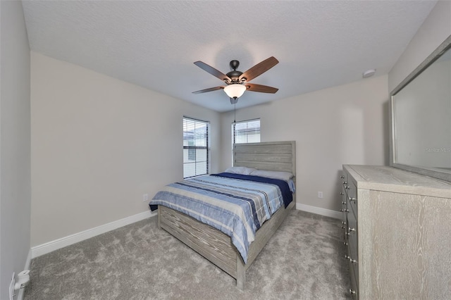 bedroom featuring carpet flooring, ceiling fan, a textured ceiling, and baseboards