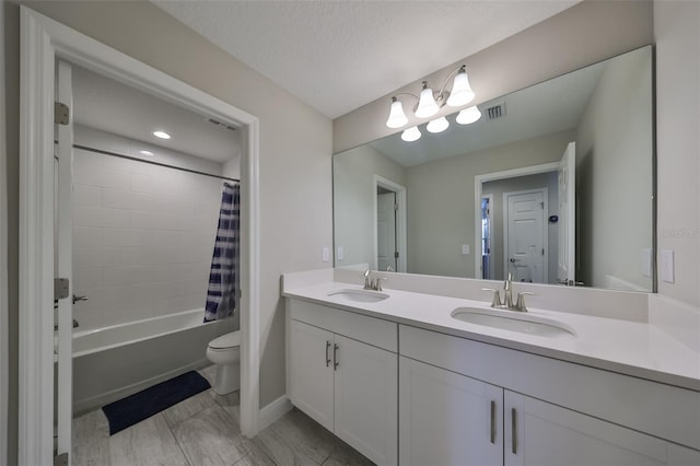 bathroom featuring shower / tub combo, a sink, toilet, and double vanity