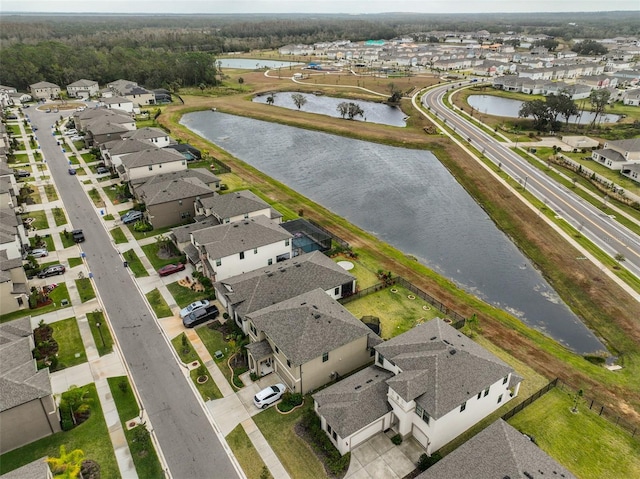 drone / aerial view with a residential view and a water view