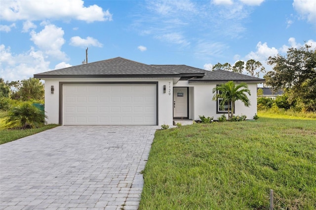 view of front of home featuring a garage and a front lawn