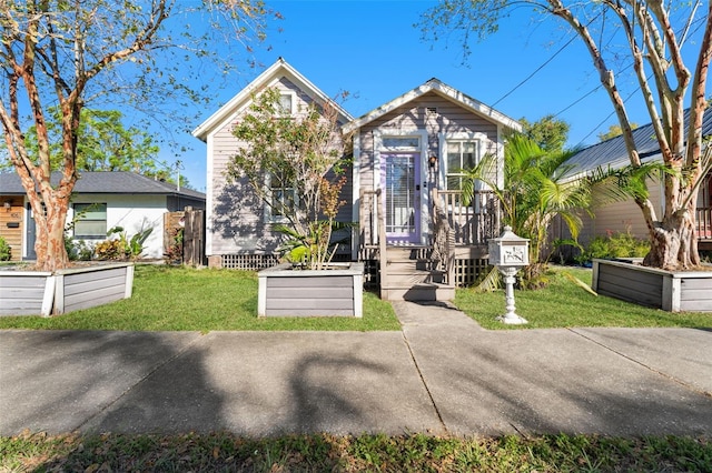 bungalow-style home with a front yard