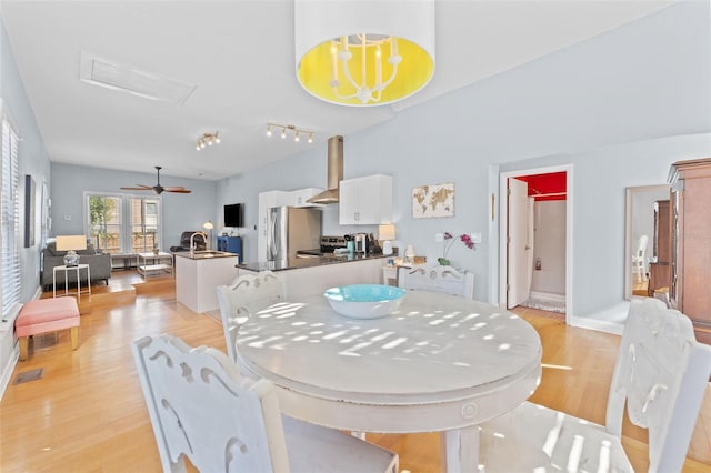 408 E Amelia Ave, Tampa, FL 33602 - dining area with light wood-style flooring and attic access