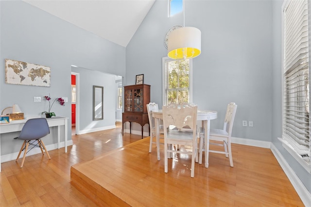 408 E Amelia Ave, Tampa, FL 33602 - dining area with high vaulted ceiling, light wood finished floors, and a desk