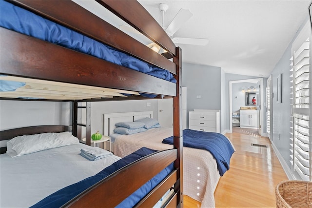 408 E Amelia Ave, Tampa, FL 33602 - bedroom with wood finished floors, vaulted ceiling, and connected bathroom