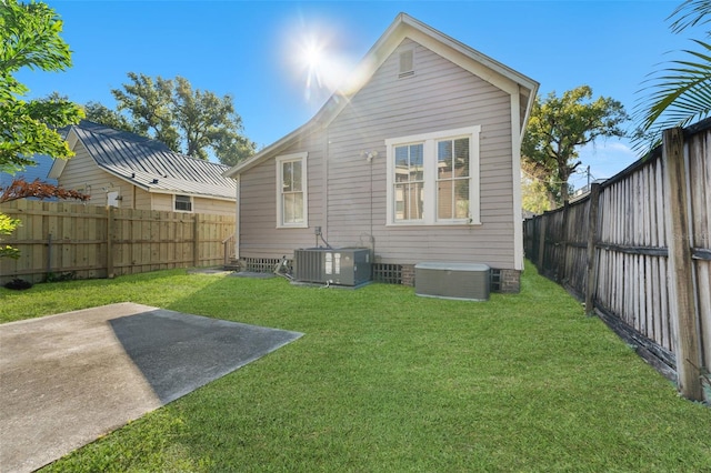 408 E Amelia Ave, Tampa, FL 33602 - back of property featuring central AC, a patio, a fenced backyard, and a lawn