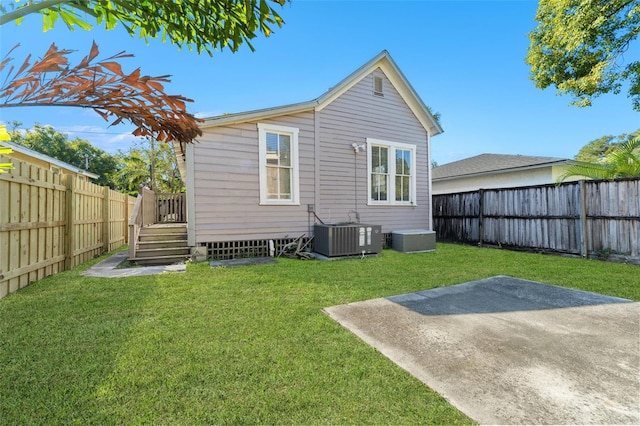 408 E Amelia Ave, Tampa, FL 33602 - rear view of house with central air condition unit, a yard, a patio area, and a fenced backyard
