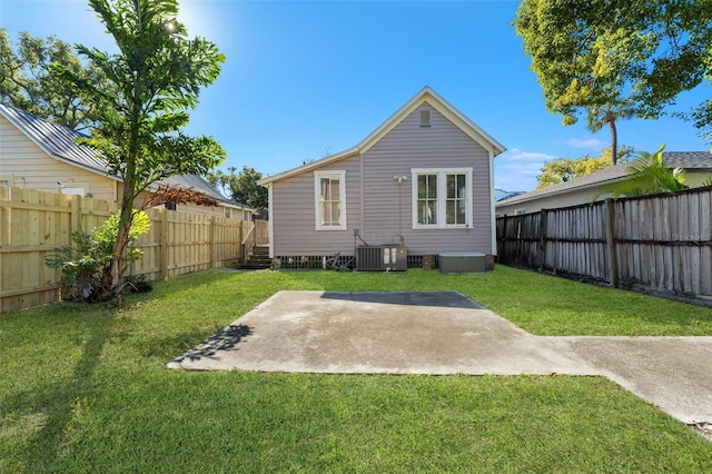 408 E Amelia Ave, Tampa, FL 33602 - back of property featuring cooling unit, a patio area, a lawn, and a fenced backyard