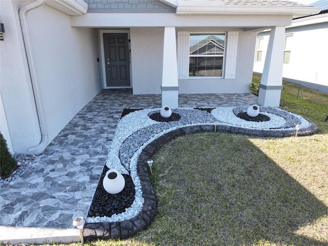 doorway to property with a lawn