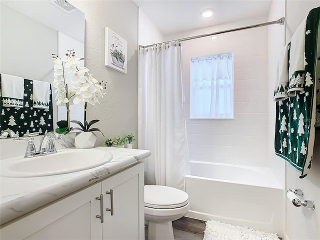 full bathroom featuring shower / tub combo with curtain, vanity, wood-type flooring, and toilet