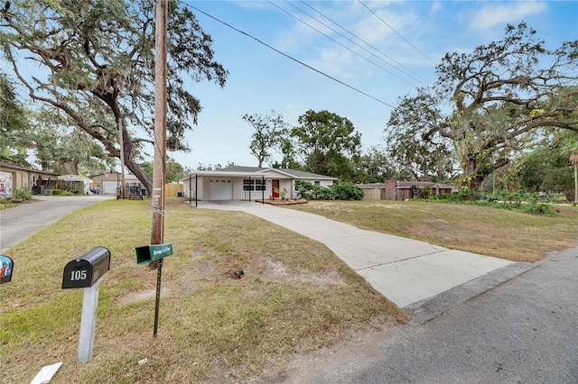 ranch-style house featuring a front yard and a garage