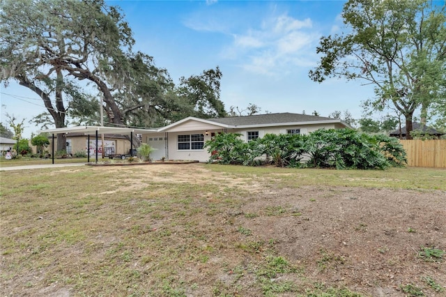 ranch-style home with a carport and a front lawn