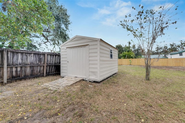 view of outbuilding with a yard