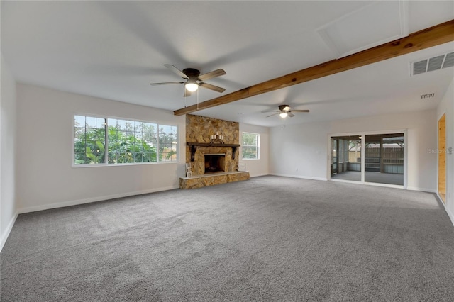 unfurnished living room featuring carpet flooring and plenty of natural light