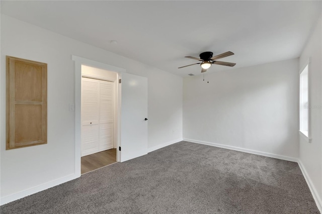 carpeted spare room with ceiling fan