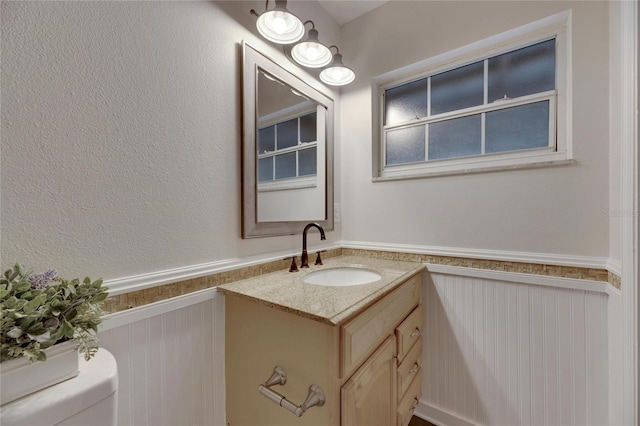 bathroom featuring vanity and toilet