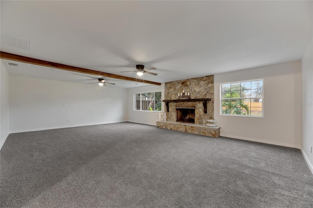 unfurnished living room featuring carpet flooring and a wealth of natural light