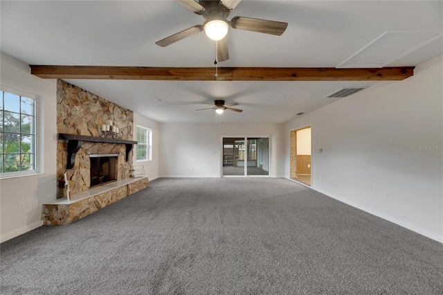 unfurnished living room with carpet flooring, a fireplace, beamed ceiling, and ceiling fan