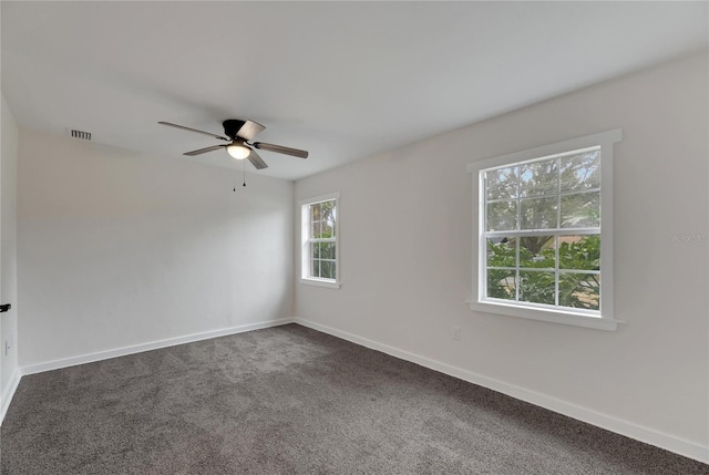 spare room featuring ceiling fan and carpet floors